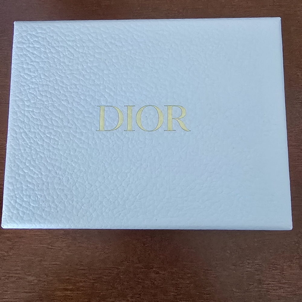 Dior mirror with lipstick.